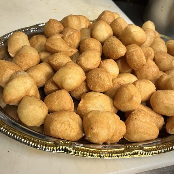 A silver platter piled high with golden-brown, bite-sized fried dough balls from Bear Mountain Pizza & Cafe.